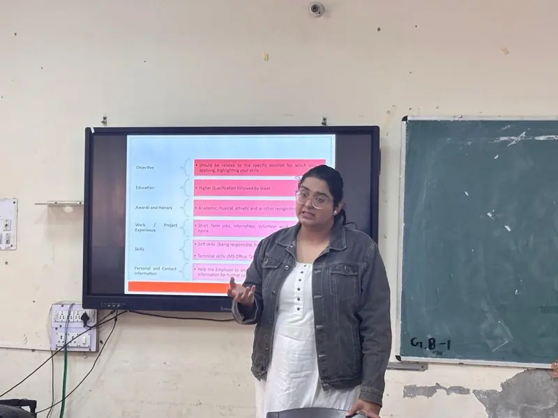 A TalkTheTalk trainer presenting a slide to the room